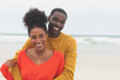 © WavebreakMediaMicro - Couple standing at beach on a sunny day
