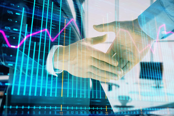 Multi exposure of financial graph on office background with two businessmen handshake. Concept of success in business