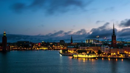 Wall Mural - Stockholm, Sweden. Time-lapse of Gamla Stan in Stockholm, Sweden with landmarks like Riddarholm Church during the sunrise. View of old buildings and cloudy sky in morning, panning video