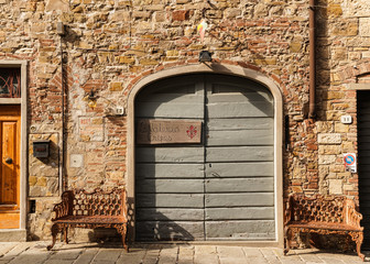 Wall Mural - old wooden door in stone wall