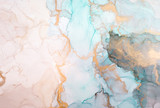 The picture is painted in alcohol ink. Creative abstract artwork made with translucent ink colors. Trendy wallpaper. Abstract painting, can be used as a background for wallpapers, posters, websites.
