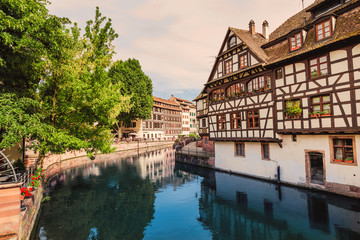 Wall Mural - Strasbourg cityscape at sunset. Famous Petite France quartier and it's reflections in Ill river