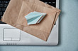 Sending e-mails and e-commerce business. Email marketing or advertising: paper airplanes, envelopes and a laptop
