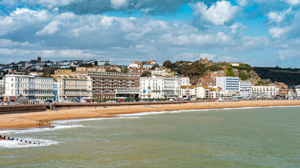 Wall Mural - Hastings Castle and seafront, England. The seafront to the East Sussex town of Hastings with its landmark castle visible on top of the hill.