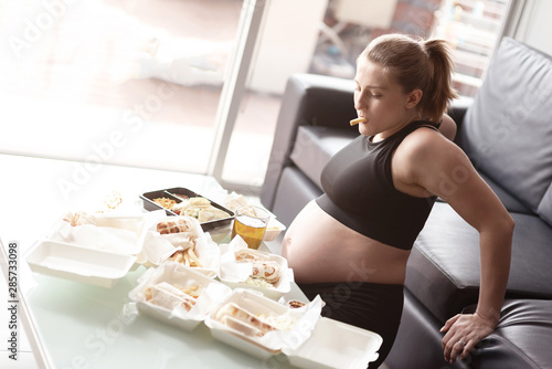 Pregnancy is my excuse. Pregnant woman eating junk food. Copy ... Pregnancy is my excuse. Pregnant woman eating junk food. Copy ...