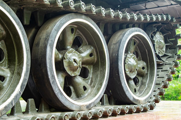 Caterpillars of a tank wheel close up.