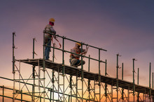 Man Working On Construction Site With Scaffold And Building With Sunset Background,scaffolding For Construction Factory