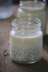 Wall Mural - black sesame soy milk in glass on wood