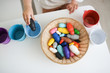© natalialeb - toddler sorts colorful toys by colored buckets