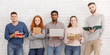 © Prostock-studio - Group of diverse friends posing with gadgets and books
