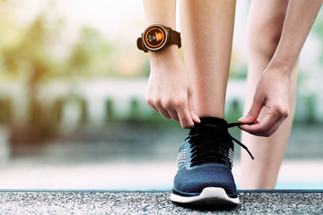 A girl using smart watch for tracking running