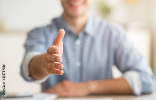 Cuadros en Lienzo Unrecognizable Young Man Stretching Hand For Handshake Greeting At Home