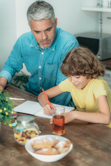 Wall Mural - Father and son making school homework at home