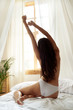 © Yakobchuk Olena - Beautiful young woman stretching after awake in her bedroom