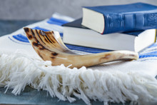 Rosh Hashanah - Jewish New Year Holiday Concept. Traditional Symbols: Shofar - Horn, Tallite And Torah On A Gray Background