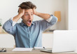 © Prostock-studio - Disappointed guy looking at laptop holding hands on head