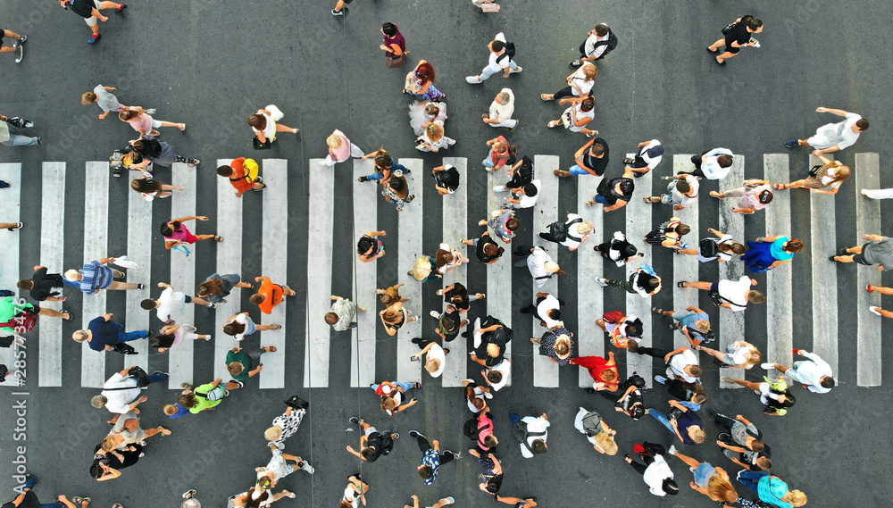 Aerial. People crowd on pedestrian crosswalk. Top view background. - obrazy, fototapety, plakaty 