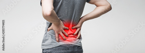 Fotografía Man holding his hands behind his back, pain in spine
