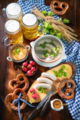 Wall Mural - Bavarian sausages with pretzels, sweet mustard and beer mugs