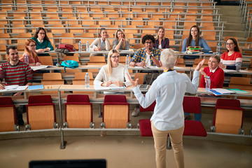 professor holding lecture to a multi ethnic group of students. young people studying at the universi