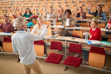 professor holding lecture to a multi ethnic of students..