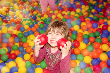 Wall Mural - beautiful child playing in a ball pool