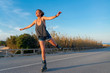 © MiguelZare - young woman skates happy outdoors