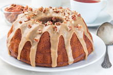 Sweet Potato And Pecan Nuts Pound Cake With Caramel Icing On White Plate, Horizontal