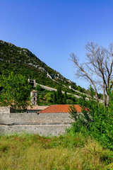 Wall Mural - Portrait format of the great old wall of Ston with an old church tower