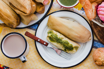 Canvas Print - mexican tamal of corn leaves with chili and green sauce, Tamale in Mexico
