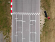 © puckillustrations - Race track with starting or end line, aerial view background