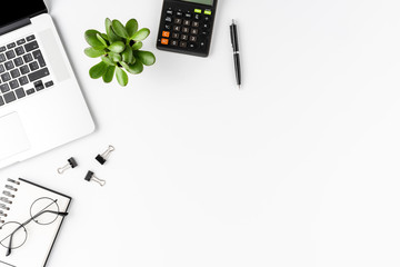 Office desktop with laptop, calculator and business accessories isolated on white background. Business concept