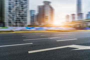 empty asphalt road near glass office building