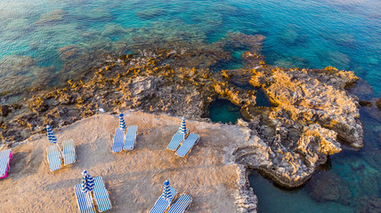 Wall Mural - Sunrise on Beach, Chairs on Secret Beach and Blue Mediterranean Sea Water, Drone View