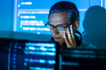 Wall Mural - young tired man freelancer in glasses is working at night because of deadline. programmer developer 