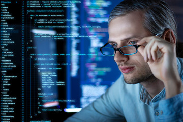 Wall Mural - young tired man freelancer in glasses is working at night because of deadline. programmer developer 