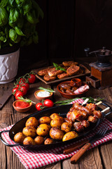 Wall Mural - Rustic dates wrapped in bacon and young roasted potato.