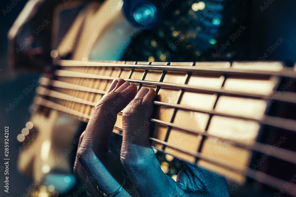 Closeup photo of bass guitar player hands - obrazy, fototapety, plakaty 