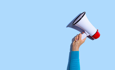 person holding a megaphone with hard shadow