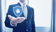 © SasinParaksa - Protection business network and digital data. Businessman holding shield with lock icon