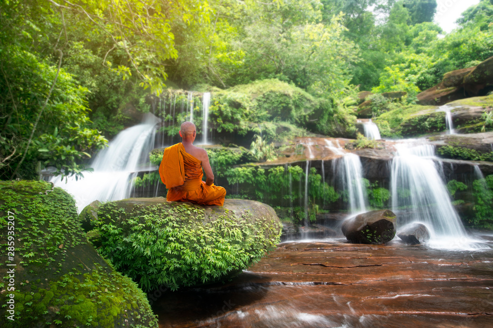 Buddha monk practice meditation at beautiful waterfall - obrazy, fototapety, plakaty 