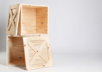 Wooden crates on grey background. Space for text