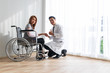 © kurapy - Young doctor encouraged the female patient on the broken arm and wheelchair patient.