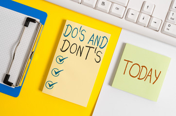 Writing note showing Do S And Dont S. Business concept for Rules or customs concerning some activity or actions Paper with copy space and keyboard above orange background table