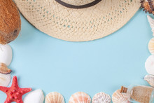 Flat Lay Composition With Beautiful Starfishes, Sea Shells, Coconut, Bottle With Sand And Straw Hat On A Blue Background, Space For Text. Copy Space