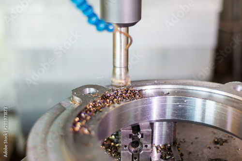 Fotomural Milling a part on a CNC machine with a high-speed milling cutter.