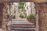 Fototapeta Uliczki - Mediterranean summer cityscape - view of a medieval street with stairs in the Old Town of Dubrovnik on the Adriatic Sea coast of Croatia