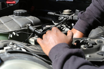 someone under the hood fixing a car