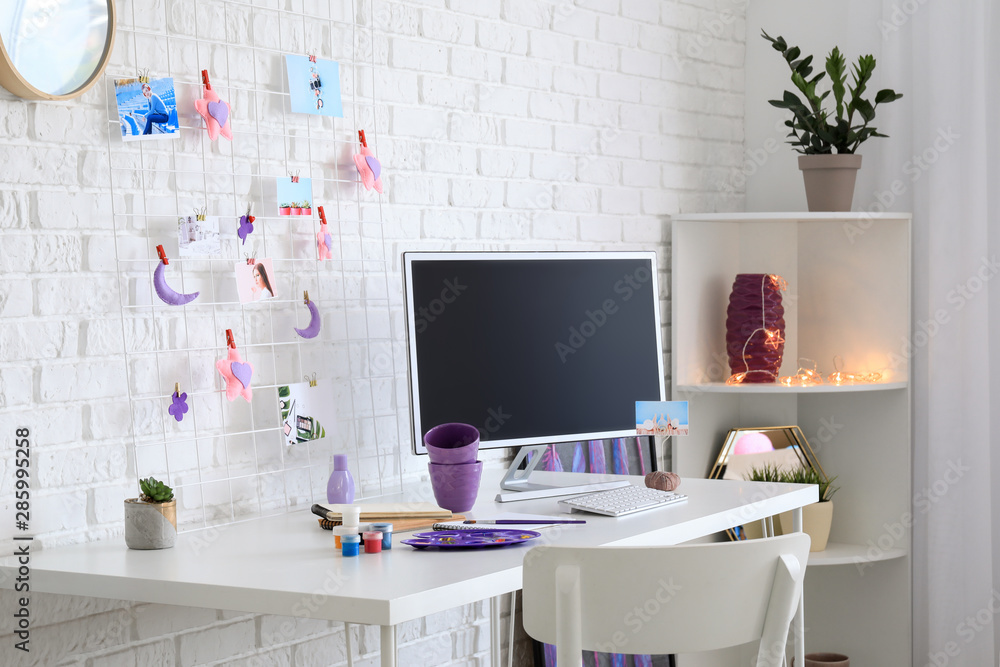 Workplace with mood board and computer in modern room
