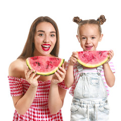 Wall Mural - Beautiful young woman and cute little girl with fresh watermelon on white background